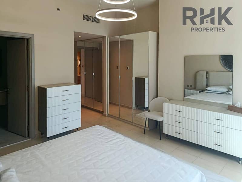 6 Master bedroom with built-in mirrored wardrobes and dresser in Dubai Marina apartment