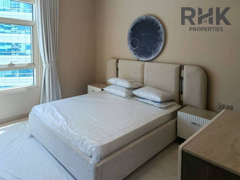 8 Furnished bedroom with queen bed and city view window in Dubai Marina apartment