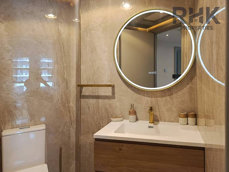 9 Marble guest bathroom with LED round mirror and gold fixtures in Dubai Marina apartment