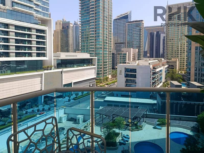 12 Balcony view of Dubai Marina skyline and community pool from high-floor apartment