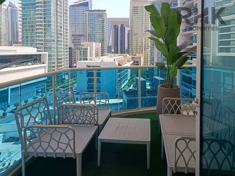 13 Furnished balcony with seating and Dubai Marina tower views from apartment terrace