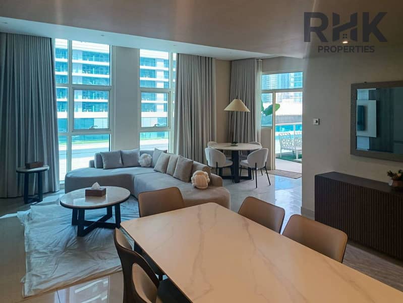 14 Bright living room with floor-to-ceiling windows and balcony access in Dubai Marina apartment