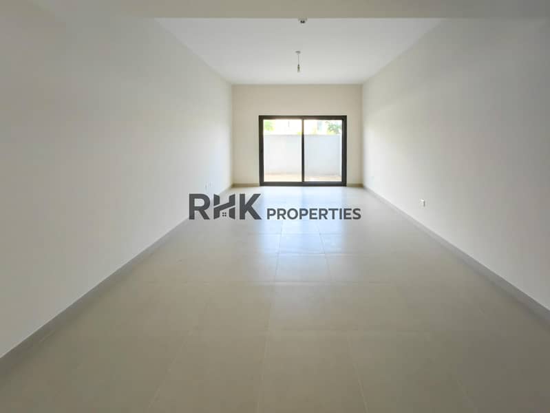 3 Spacious empty living room with large sliding door and private garden access in Dubai townhouse