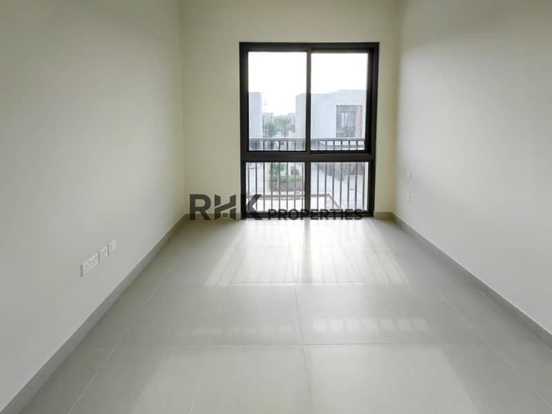4 Bright bedroom with sliding window balcony overlooking townhouse community in Dubai