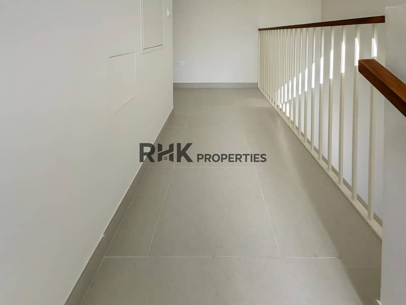 19 Upper floor hallway with white balustrade railing and tiled flooring in Dubai townhouse