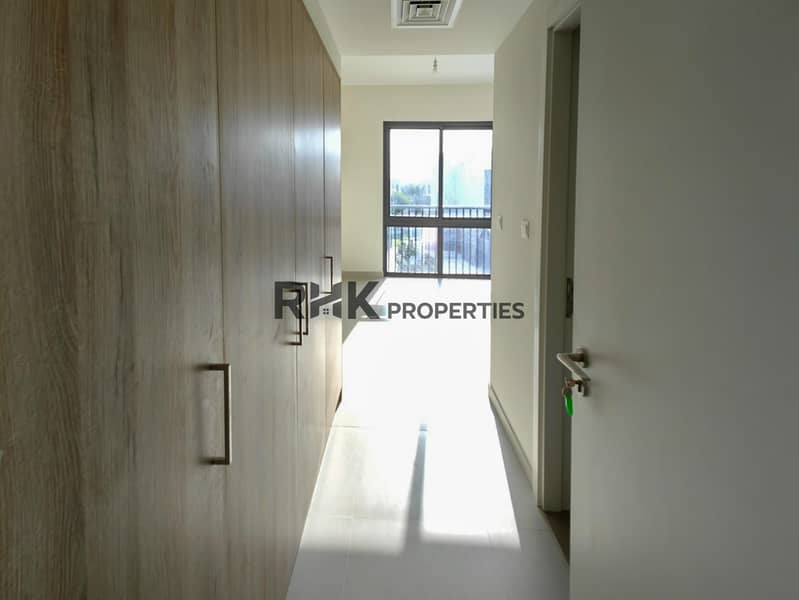 27 Sunlit bedroom with full-height wood fitted wardrobe and balcony window in new Dubai townhouse