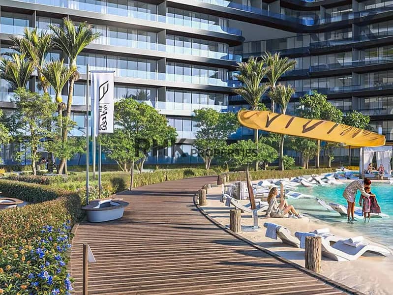 7 Resort-style pool and beach deck with palm trees at luxury Dubai residence
