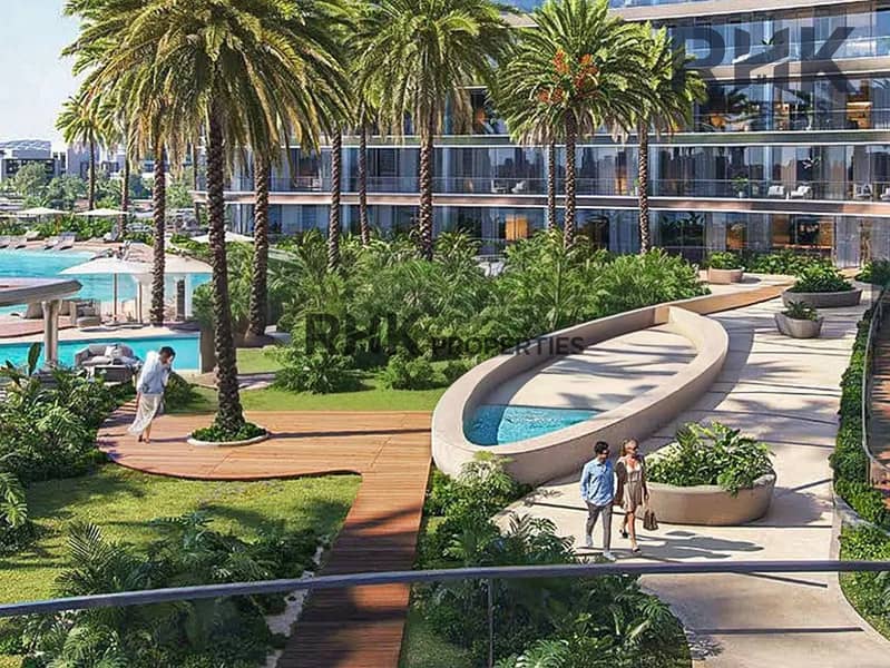 8 Landscaped garden walkway with palm trees beside pool at Dubai luxury tower