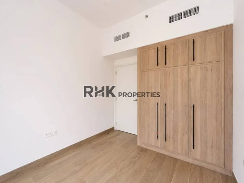 5 Spacious bedroom with fitted wardrobe and wood flooring, Town Square Dubai