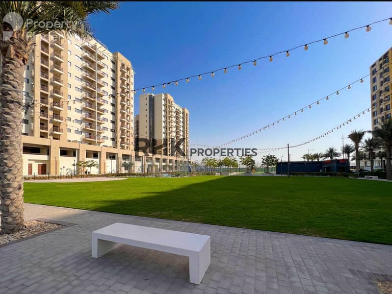 9 Landscaped park and residential buildings in Town Square Dubai community