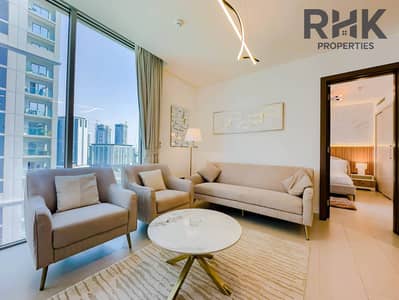 2 Camere Appartamento in affitto a Sobha Hartland, Dubai - Furnished living room with floor-to-ceiling windows and Dubai Creek Harbour skyline view in luxury apartment