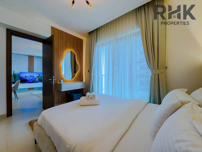 5 Bedroom with designer vanity mirror and open door to living area in Dubai Creek Harbour residence