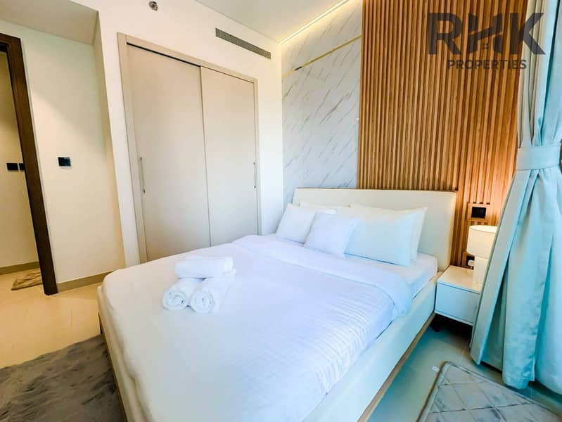 9 Second bedroom with king bed and balcony seating in luxury Dubai Creek Harbour apartment