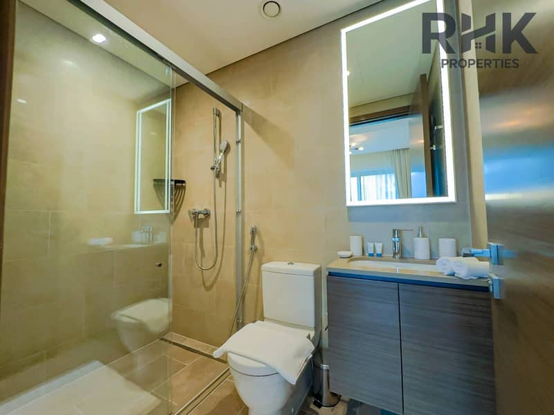 13 Modern bathroom with walk-in shower, LED mirror and vanity in Dubai Creek Harbour apartment