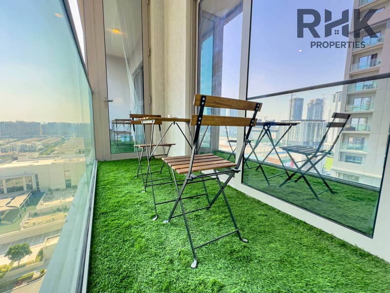 14 Private balcony with bistro seating and panoramic community views in high-rise Dubai apartment