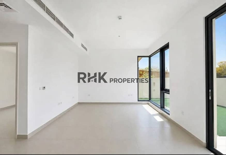 8 Spacious living room with floor-to-ceiling sliding doors opening to private garden in Dubai