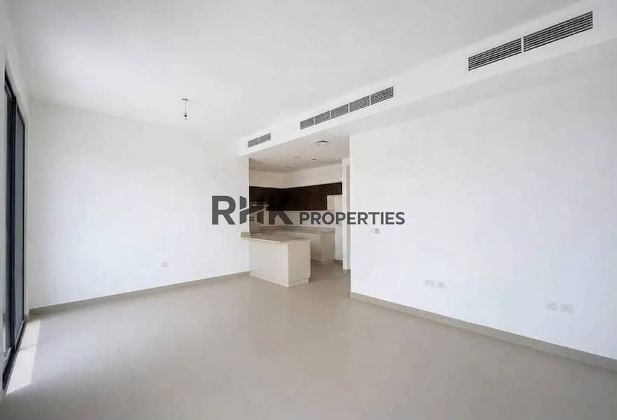 3 Open-plan living and dining area with semi-open kitchen island in modern Dubai townhouse