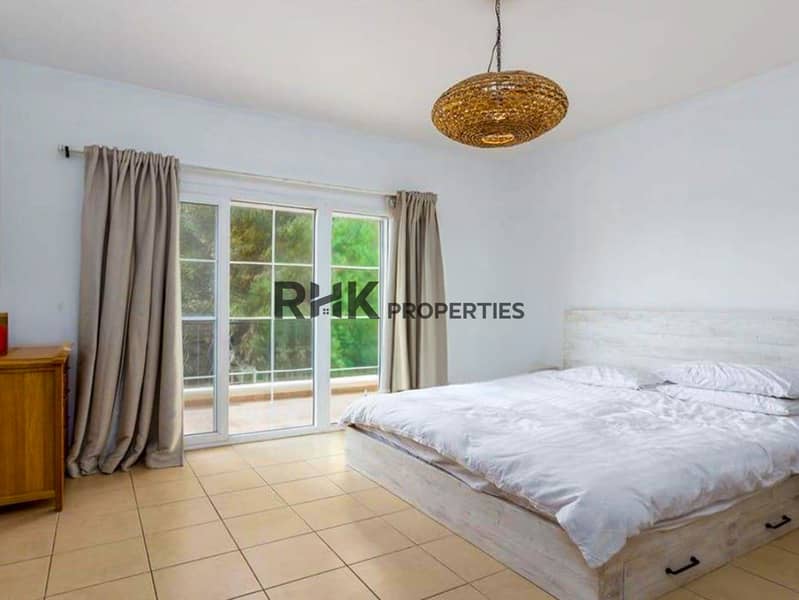 3 Bright master bedroom with balcony access, floor-to-ceiling windows, and rattan pendant light