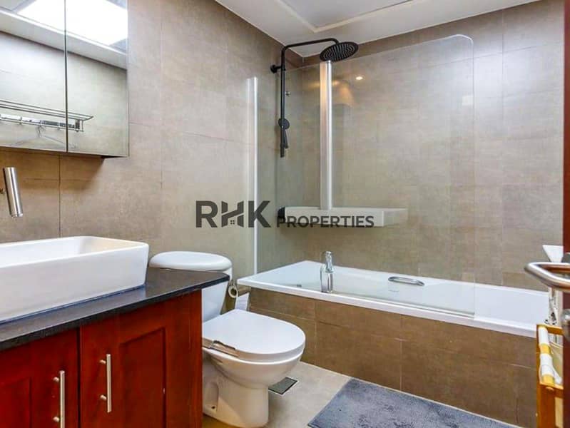 9 Luxury master bathroom with soaking tub, rain shower, and cherry wood vanity