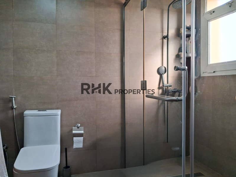 10 Contemporary bathroom with large-format grey tiles and glass-panel walk-in shower