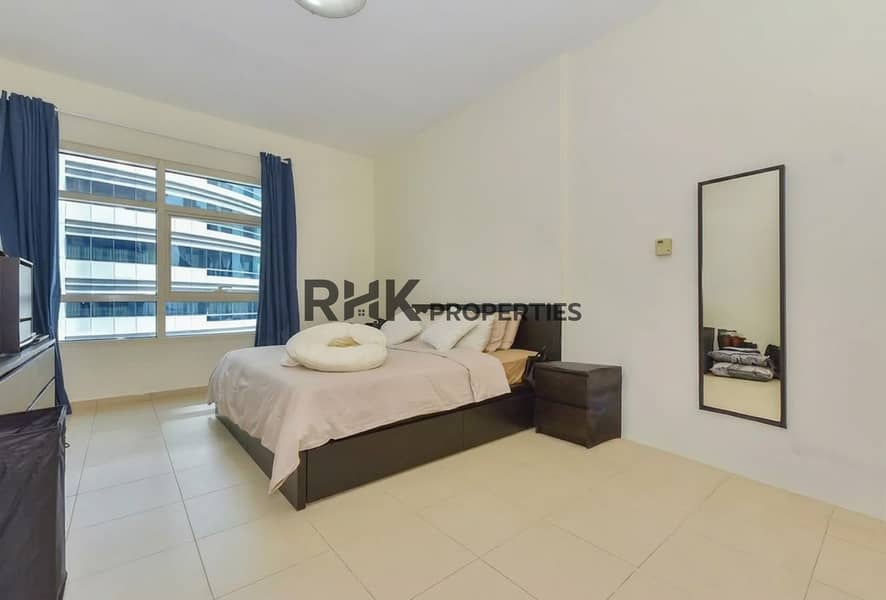 6 Spacious furnished bedroom with large window in a 2BR Yacht Bay Dubai Marina apartment