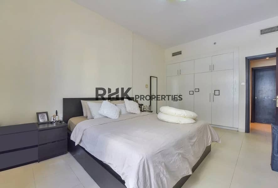 7 Furnished main bedroom with built-in wardrobes in a 2BR apartment for rent in Yacht Bay