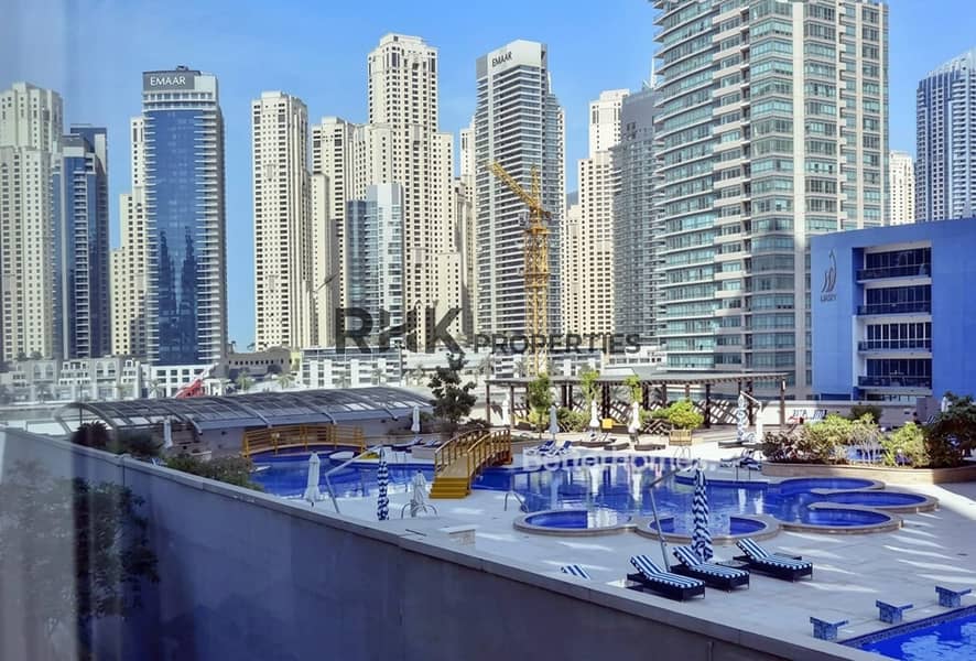 10 Swimming pool and Dubai Marina skyline view from a 2-bedroom apartment in Yacht Bay