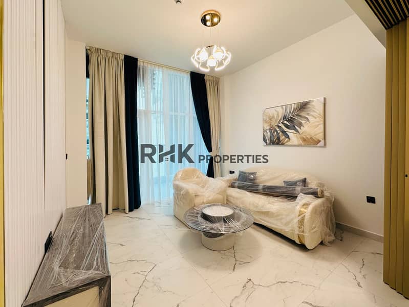 Elegant furnished living room with cream sofa set, glass coffee table, floor-to-ceiling curtains, designer chandelier, and city view balcony in luxury Dubai apartment Elegant furnished living room with cream sofa set, glass coffee table, floor-to-ceiling curtains, designer chandelier, and city view balcony in luxury Dubai apartment