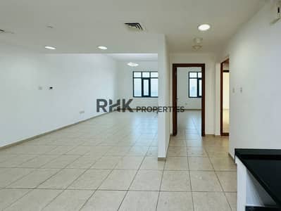 2 Bedroom Apartment for Rent in Dubai Silicon Oasis (DSO), Dubai - Spacious unfurnished living room with open floor plan, beige ceramic tiles, recessed lighting, and city view windows in Dubai apartment