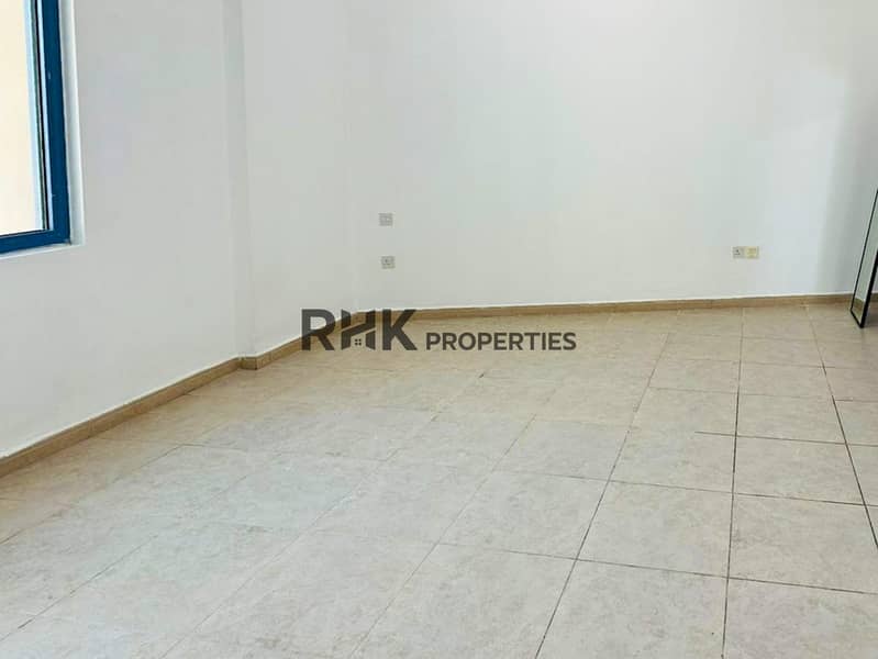 9 Compact unfurnished room with tiled flooring, white walls, window, and multiple power outlets in Dubai apartment