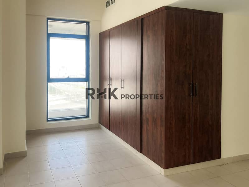 4 Floor-to-ceiling dark wood built-in wardrobe with window in Dubai residential apartment