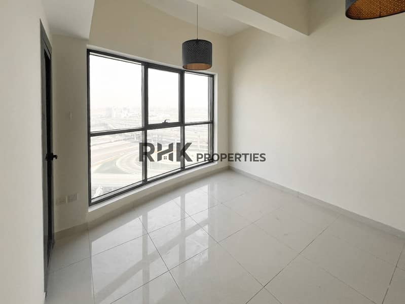 2 Modern bedroom with large window overlooking Dubai highway and city skyline, glossy tiled floor