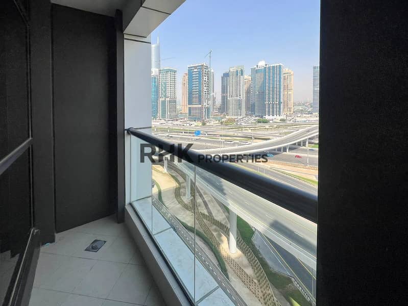 9 Balcony with glass railing overlooking Sheikh Zayed Road and Dubai Marina skyline