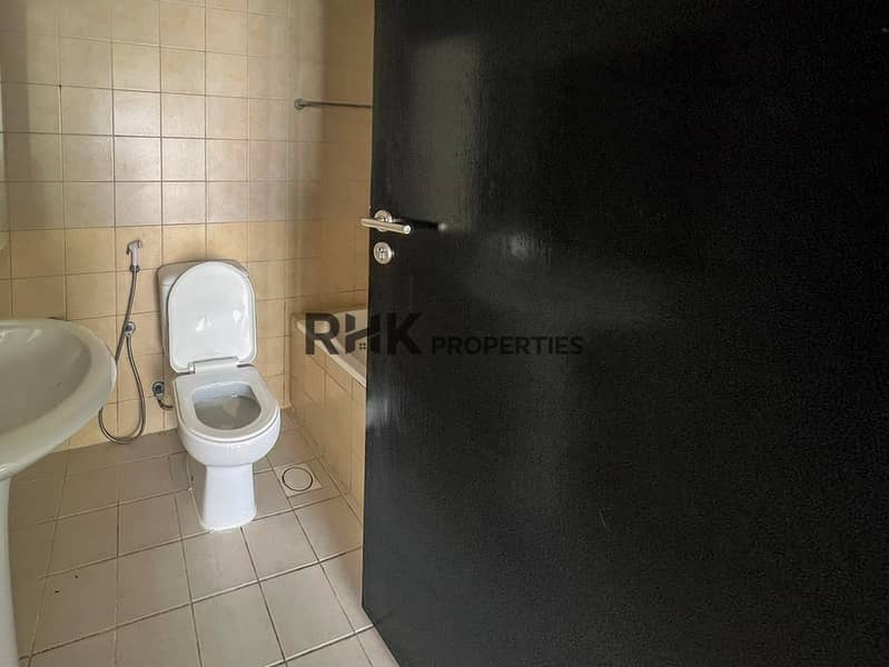 10 Bathroom with bathtub, toilet, and beige wall tiles in Dubai apartment