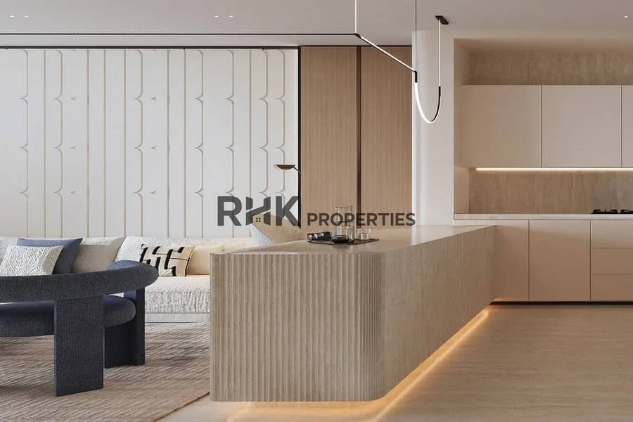 4 Open-plan living and kitchen with fluted island travertine finishes and blue boucle seating Dubai