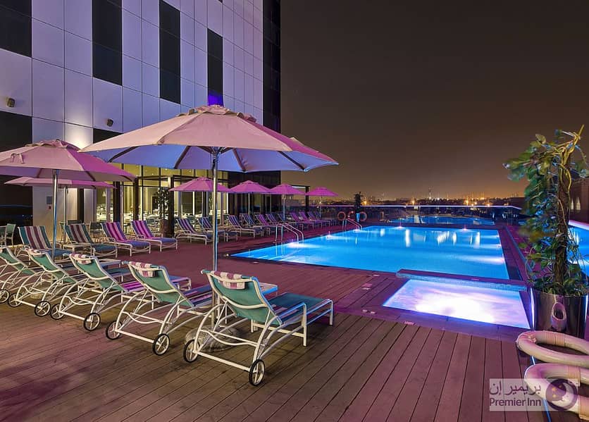 9 Premier-Inn-Ibn-Battuta-Mall-Hotel_SwimmingPool_Evening. jpg