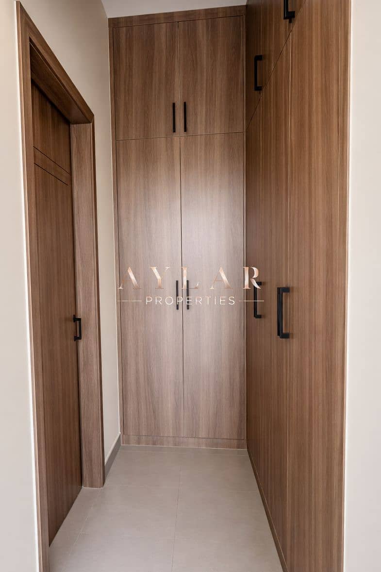 16 Sleek walnut wardrobes in warm space. png