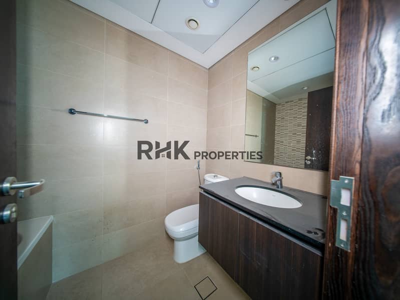 4 Modern apartment bathroom with vanity sink, large mirror and contemporary tile finishes