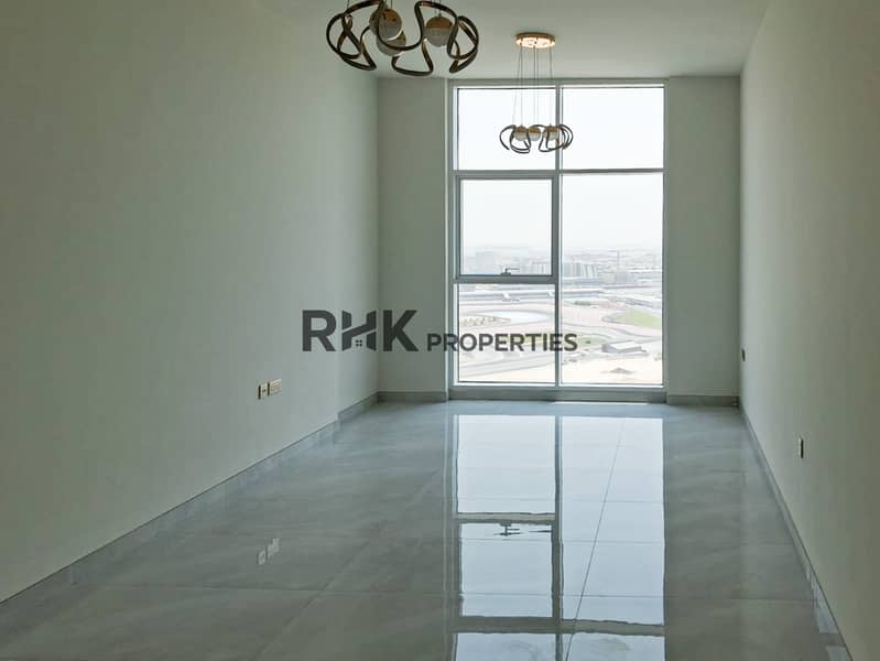 3 Bright unfurnished living room with panoramic racing circuit view in Dubai high-rise apartment