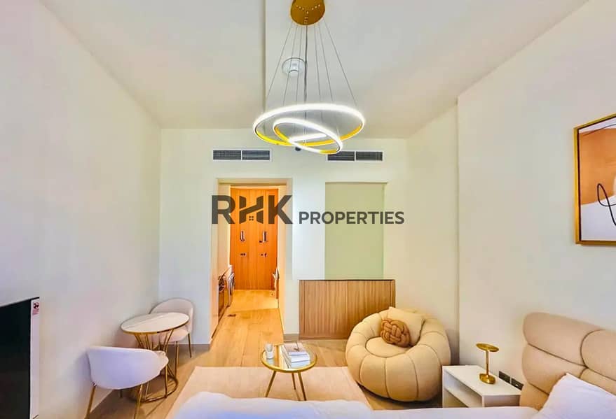 2 Modern studio apartment interior in MBR City Dubai with designer ring chandelier and dining area