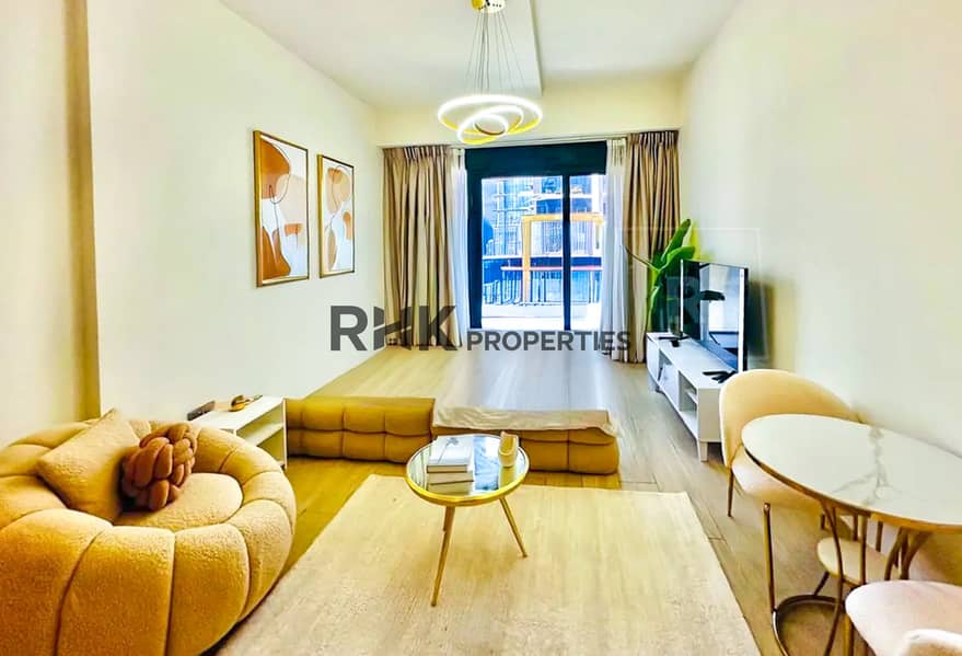 3 Open-plan furnished studio for rent in Azizi Riviera Meydan with lounge, dining table and smart TV