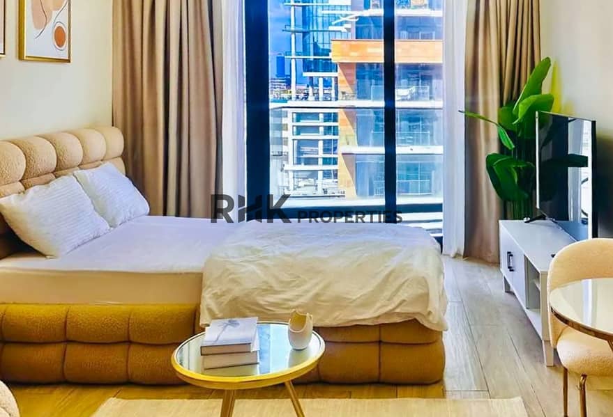 4 Double bed with boucle headboard and Dubai skyline view in a furnished Meydan studio apartment