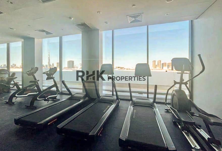 10 Residents gym with treadmills and Burj Khalifa view at Azizi Riviera community in Meydan Dubai