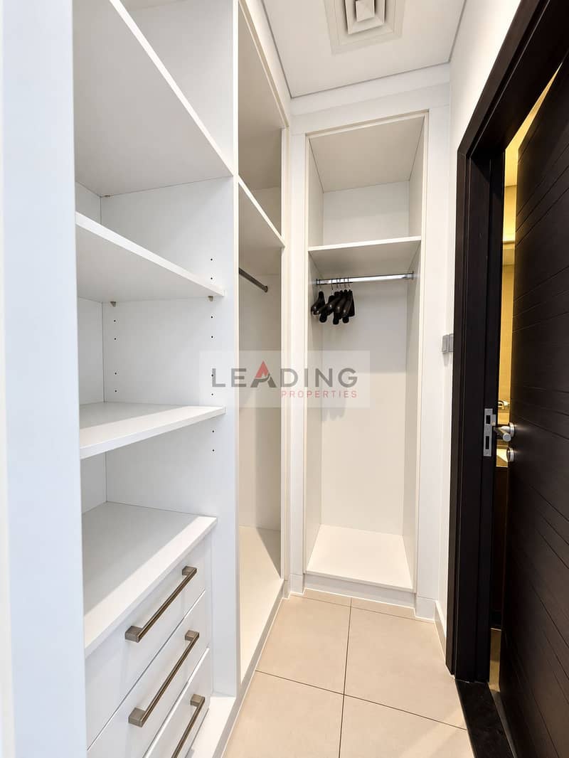 22 Bright, polished walk-in wardrobe. png