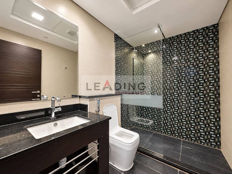 24 Pristine bathroom with polished stone vanity. png