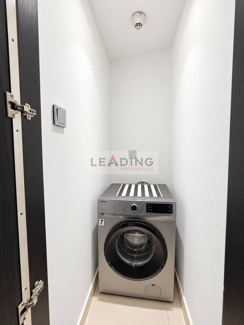 35 Pristine Silver Washer in Narrow Laundry Closet. png