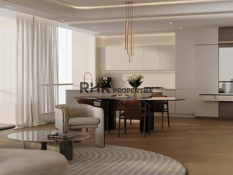 5 High-end apartment open-plan kitchen and dining area with marble island, brass faucet, rose gold pendant lights and floor-to-ceiling windows in Dubai luxury development