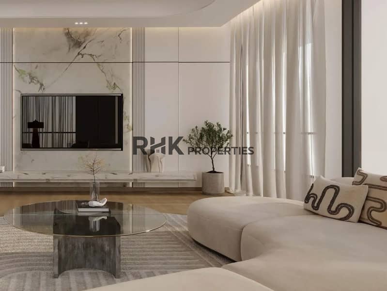 3 Contemporary luxury apartment living room with Calacatta marble feature TV wall, curved beige sofa, and smoked glass coffee table in Dubai residential tower