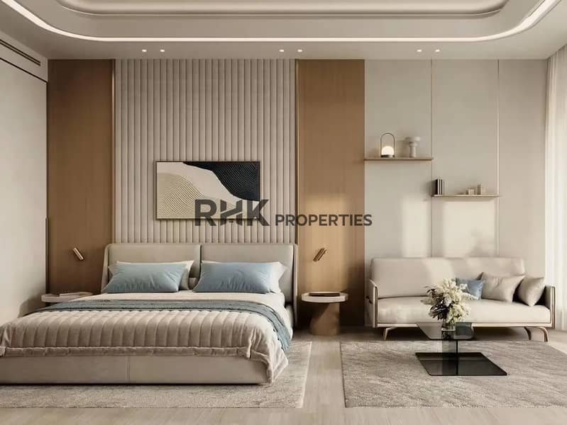 9 Modern luxury bedroom with padded fabric headboard, fluted timber feature wall, abstract canvas artwork, sitting sofa and gold accent wall lights in Dubai apartment