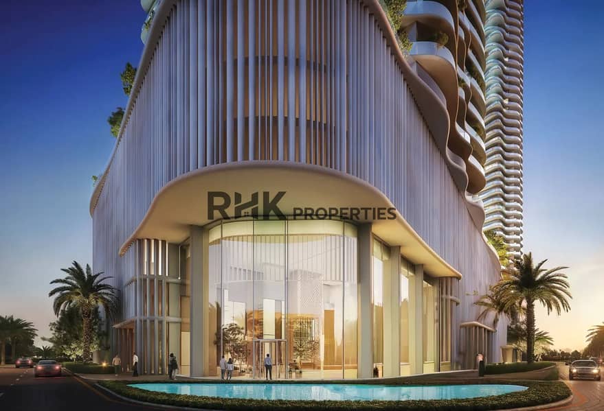 9 luxury apartment building entrance lobby Dubai illuminated glass facade sunset